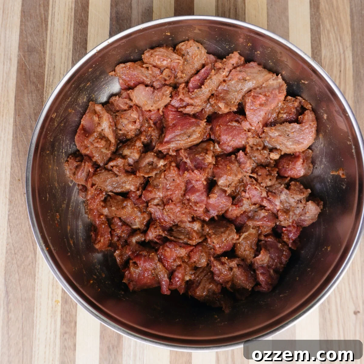 Seasoned steak bites in a bowl.