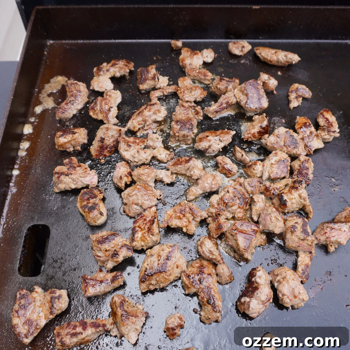 sirloin steak pieces on a griddle.