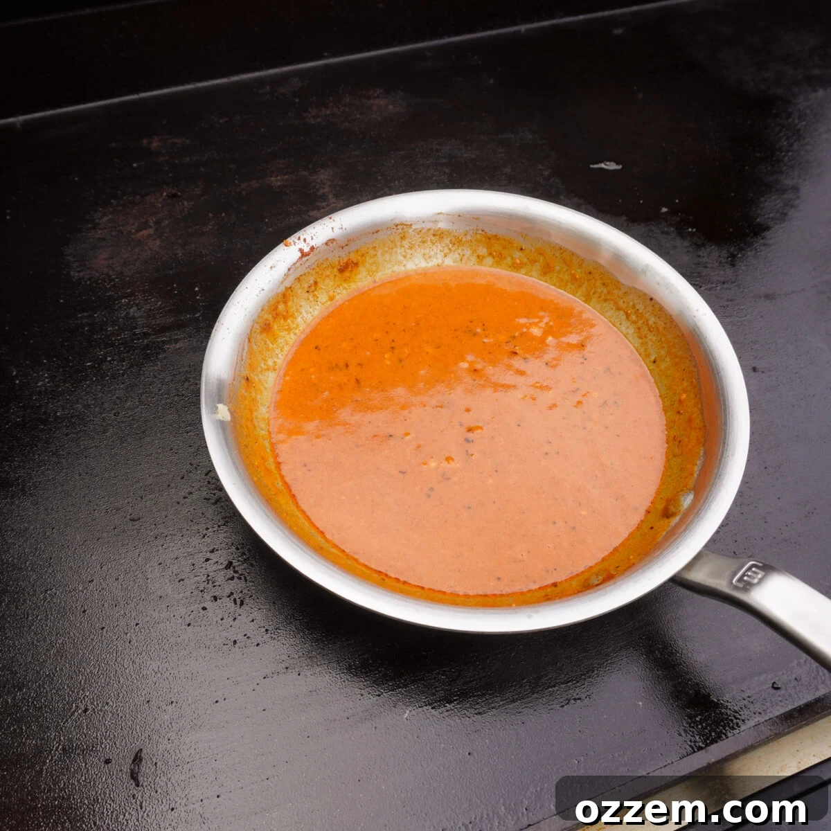 cowboy butter sauce in a saucepan on the griddle.