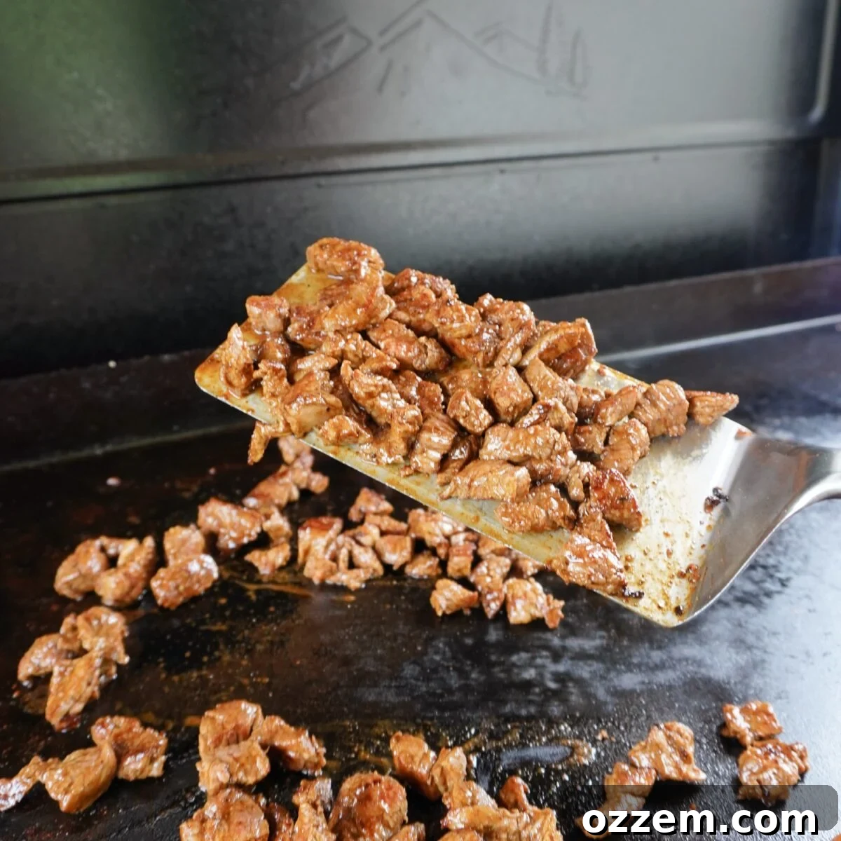 Grilled flank steak cubes on the griddle.