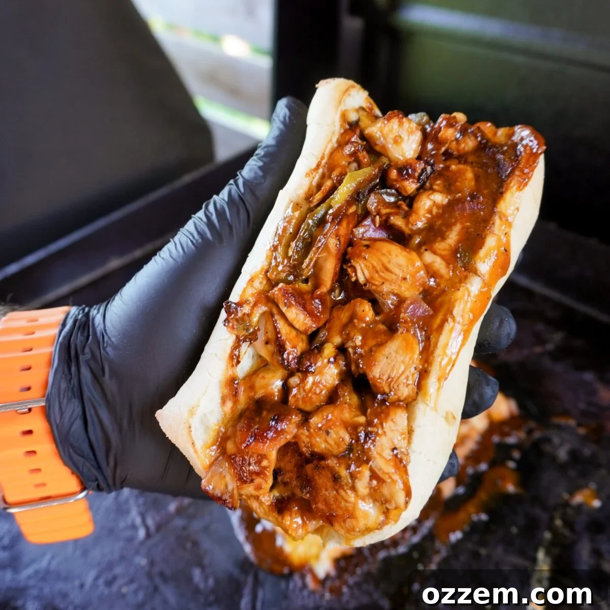 hand held chopped spicy chicken sandwich.