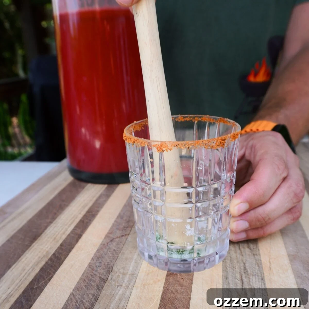 How to Make Refreshing Watermelon Juice at Home 7 Muddling sugar and mint in glass.