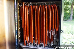 Spicy Jalapeño Cheddar Venison Snack Sticks Recipe 14 Venison snack sticks hanging in smoker.