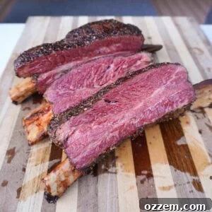Sliced Smoked Pastrami Beef Ribs on a cutting board.