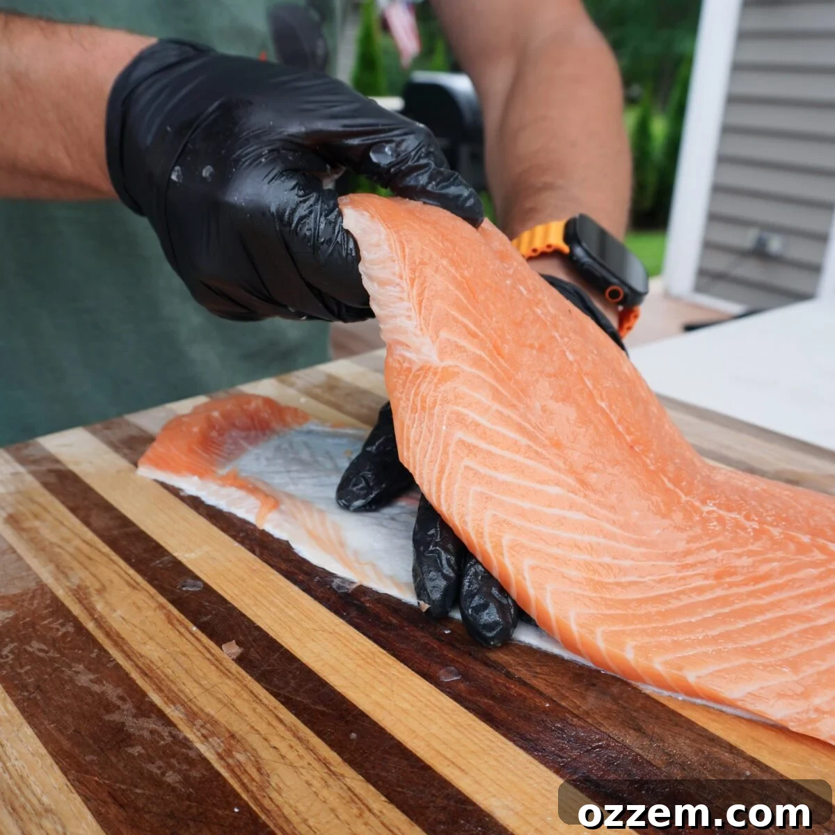 Showing how to separate salmon skin from meat.