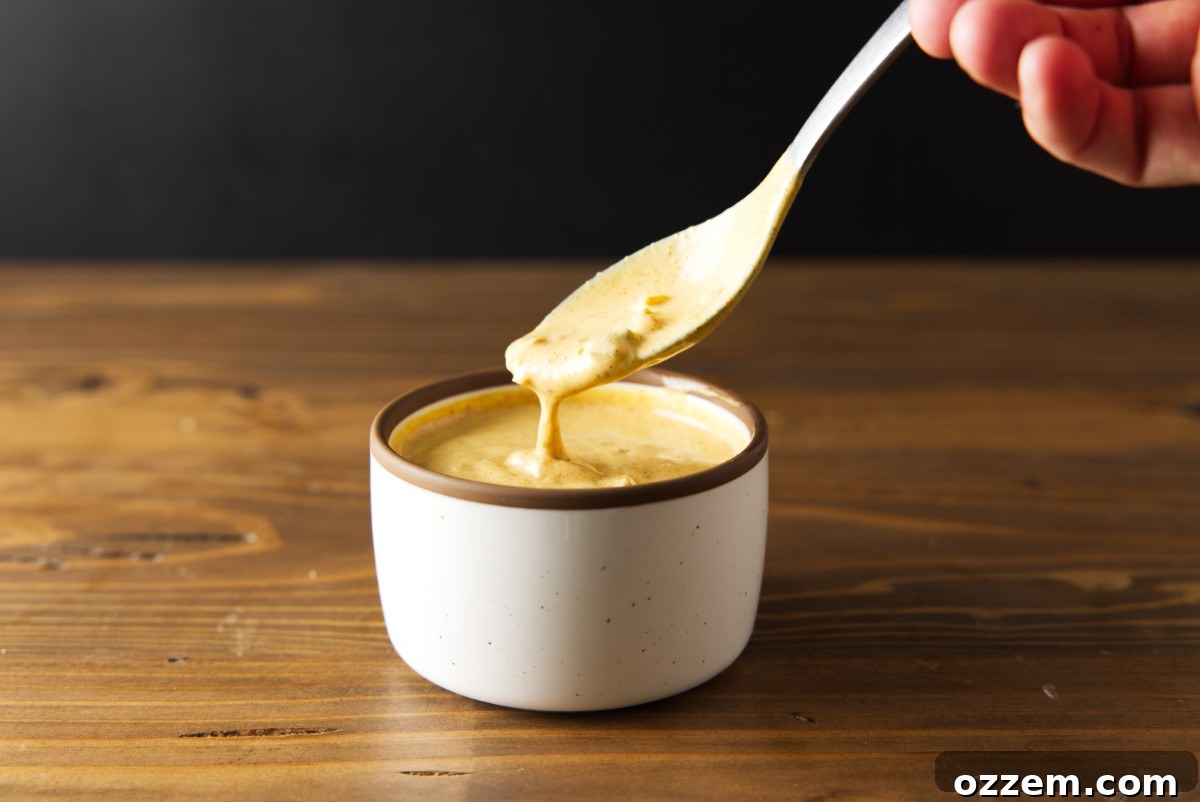 Smash burger sauce in a bowl with a spoon scooping out some.