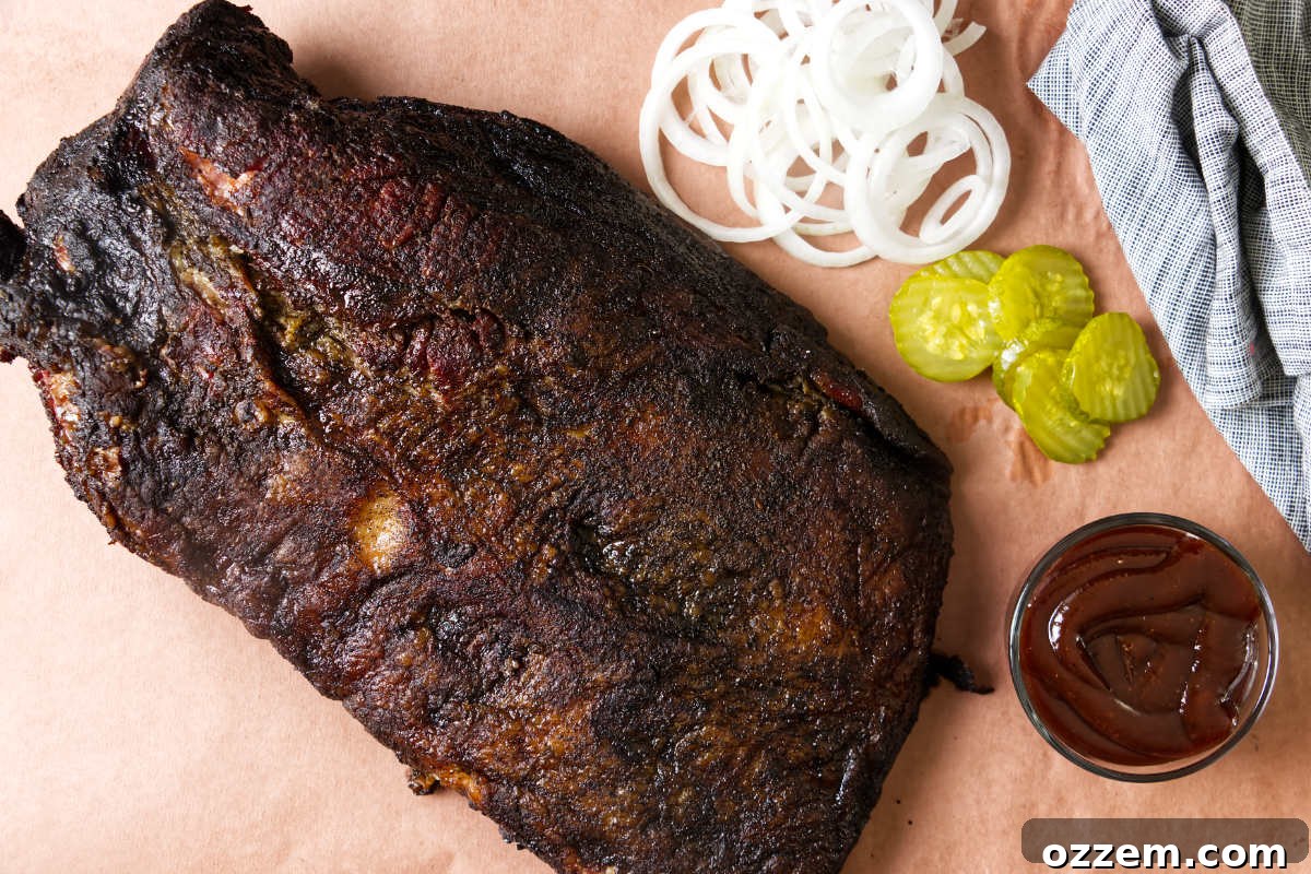 A smoked brisket on peach paper showing the dark bark.