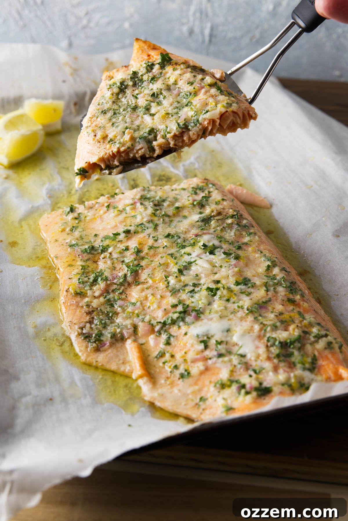 Smoky Pellet Grill Salmon Recipe 2 Slicing and serving a piece of pellet grill salmon using a fish turner.