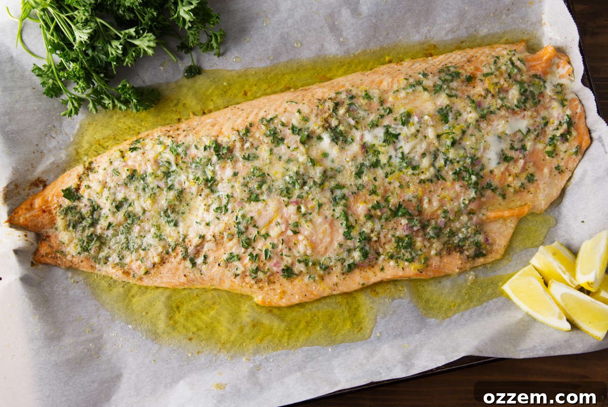 Smoky Pellet Grill Salmon Recipe 5 Pellet grill salmon coated in compound butter resting on parchment paper.