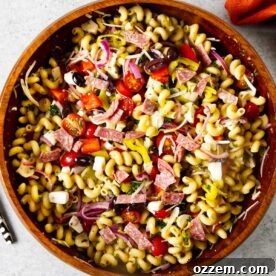 A closeup of Italian pasta salad with smoked vegetables and salami.