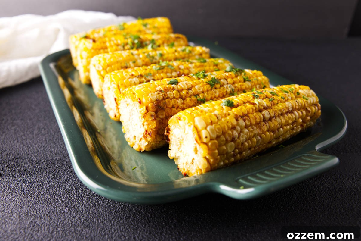 Close-up of pellet grill smoked corn on the cob with smoky barbecue butter.
