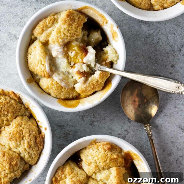 peach cobbler in ramekins with whipped cream on the side